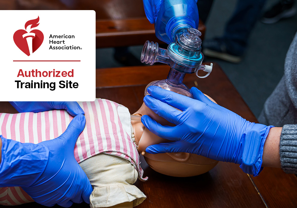 Paramedic student practicing rescue breathing on a child mannequin during training